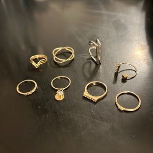 Costume jewelry. All except the two on the thumb are below a size 7 in rings